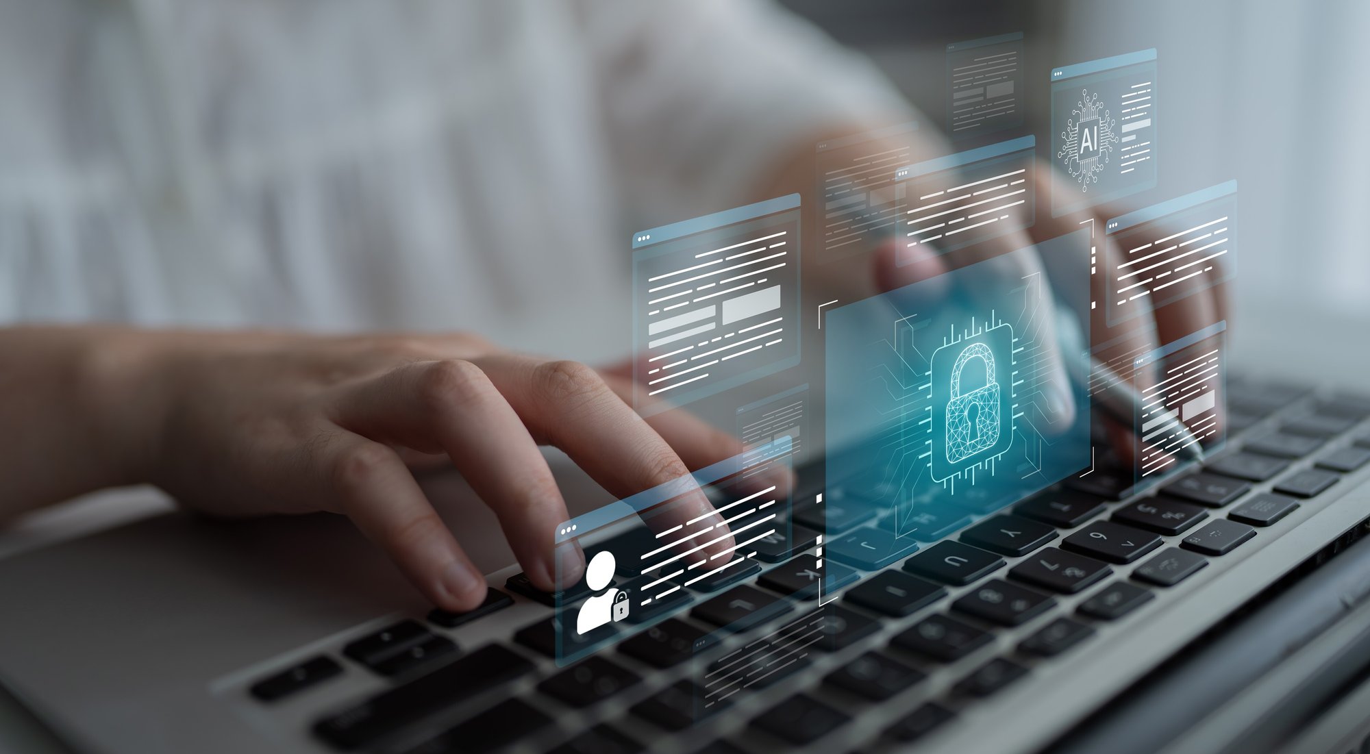 Close-up of person typing on a laptop with tech security concepts