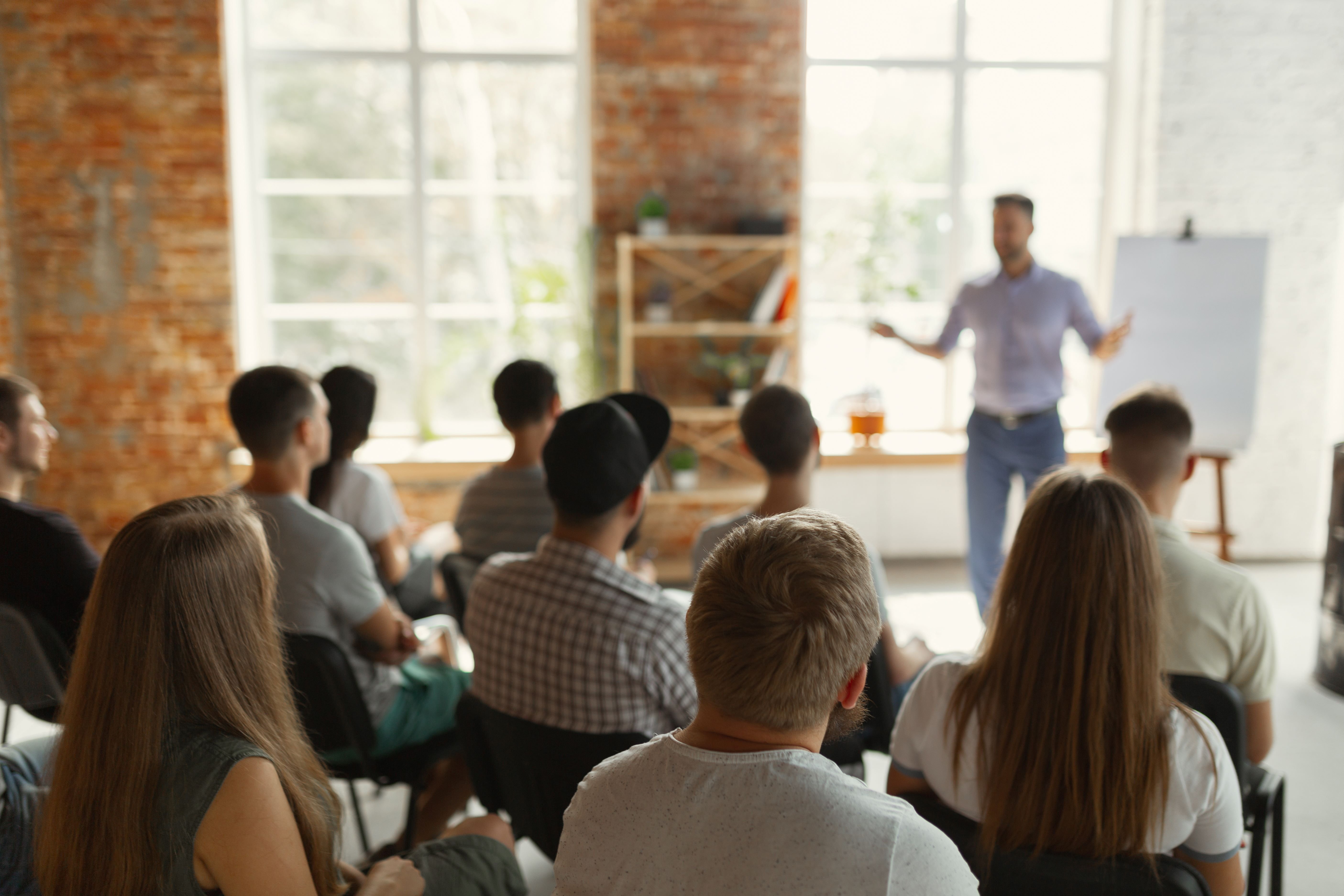 Man leads training session with team of staff