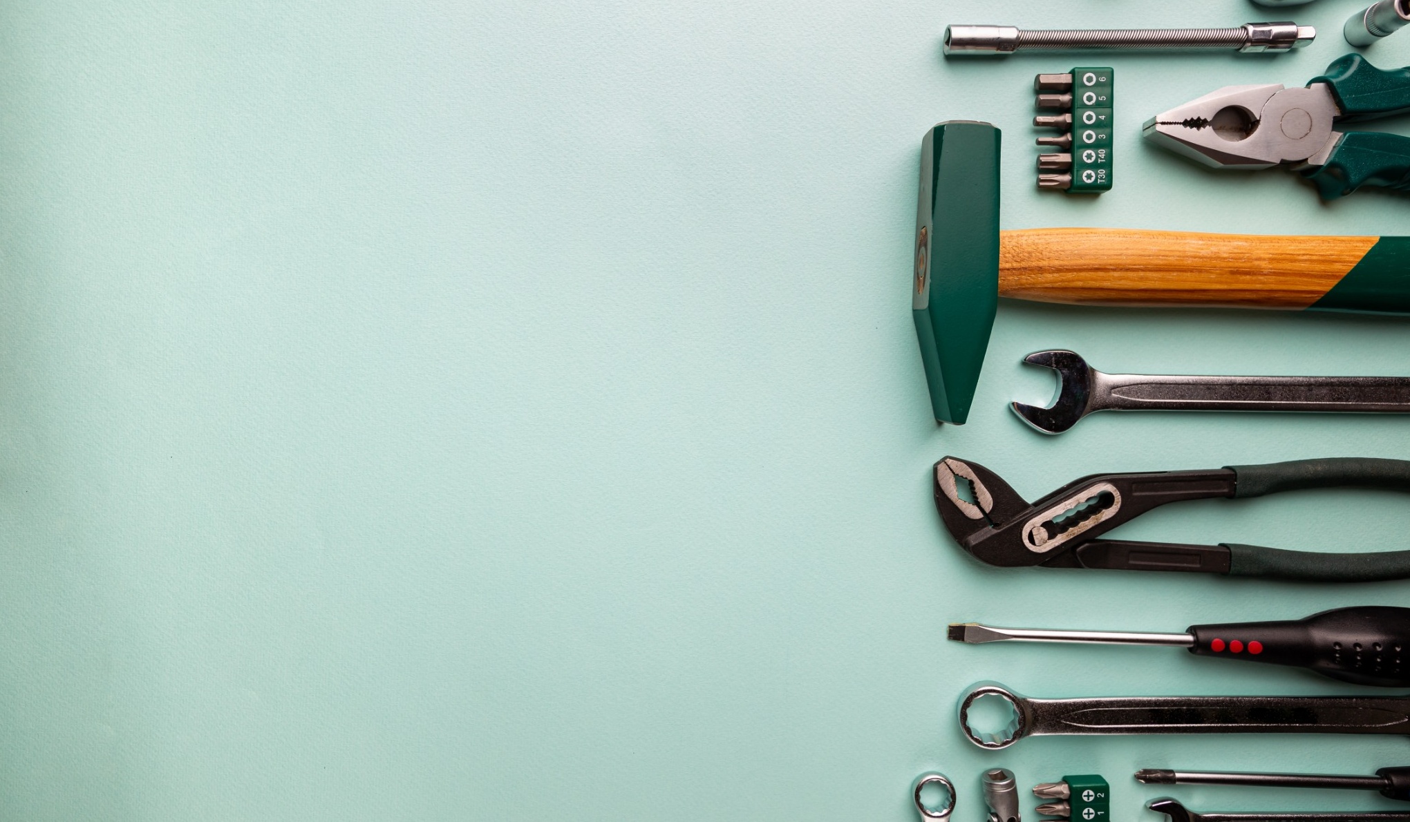Set of tools over blue background, top view with space for text