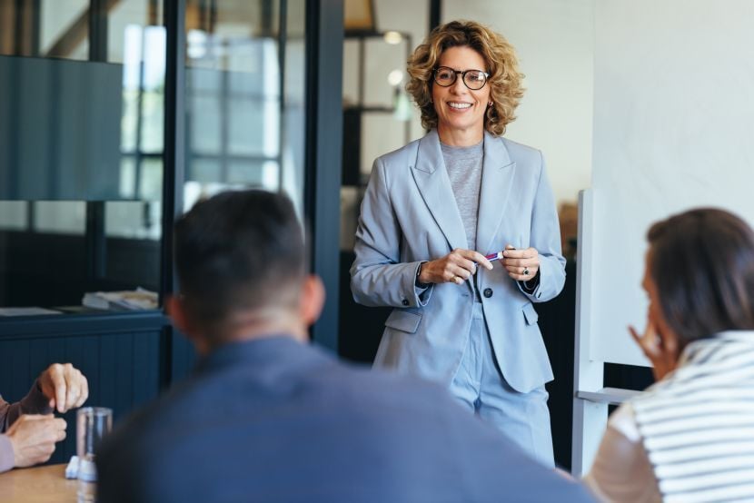 Business woman having a discussion with her team. Woman leading a meeting in an office