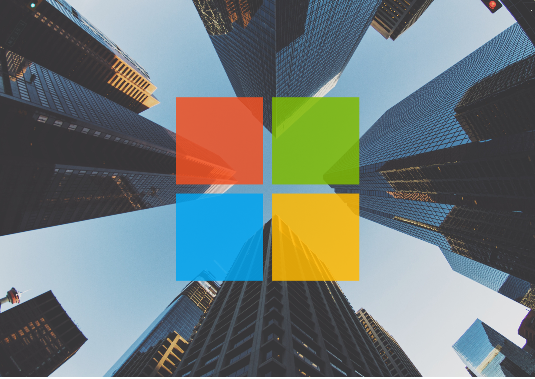 Microsoft logo overlaid on city high rise buildings.
