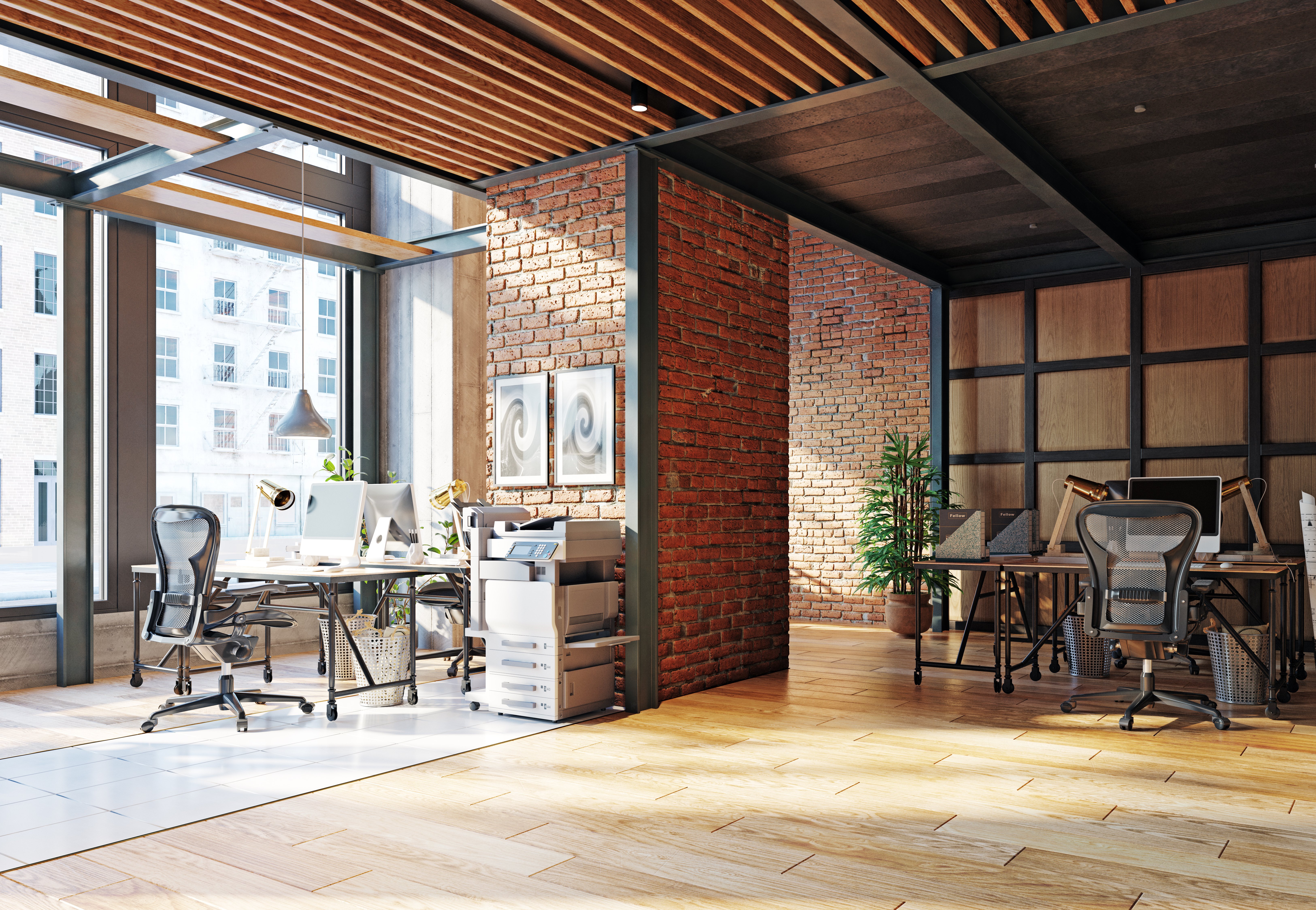 A modern office with brick walls and wooden floors.